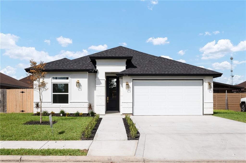 Front Stone/Stucco Professionally Landscaped with attached 2-Car garage