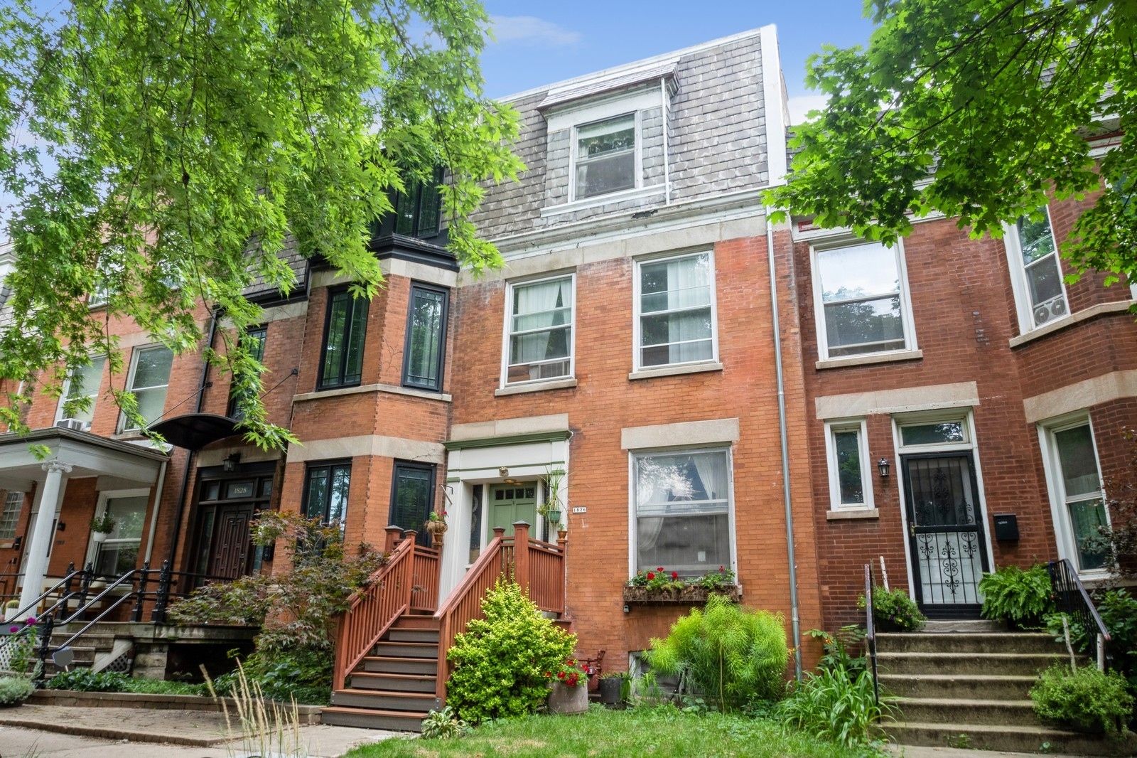 a front view of a residential apartment building with a yard