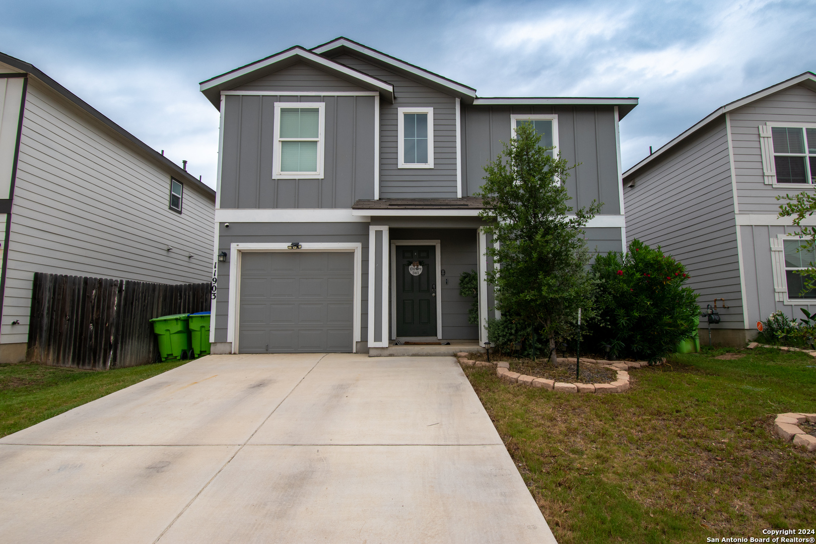 a front view of a house with yard and green space