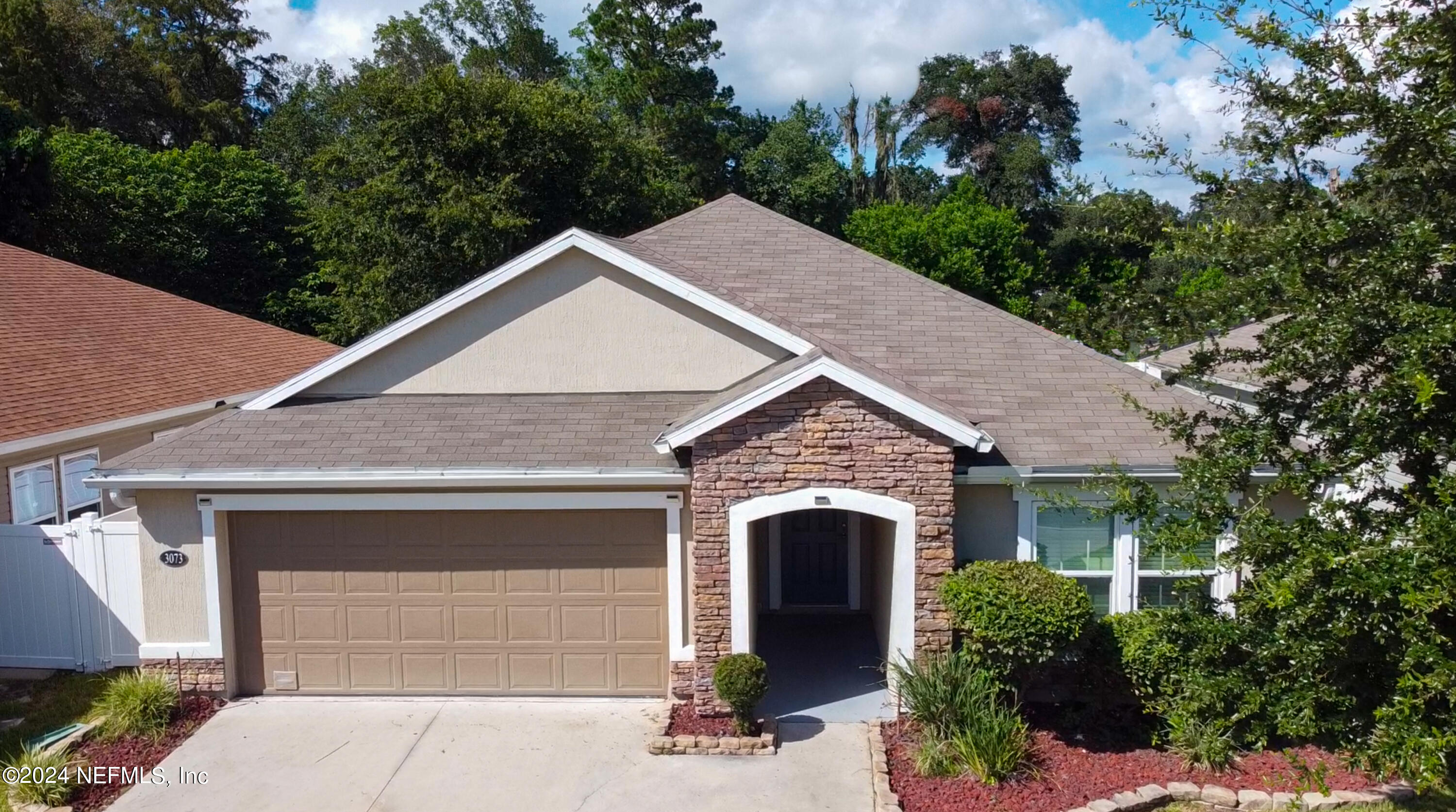 a front view of a house with garage