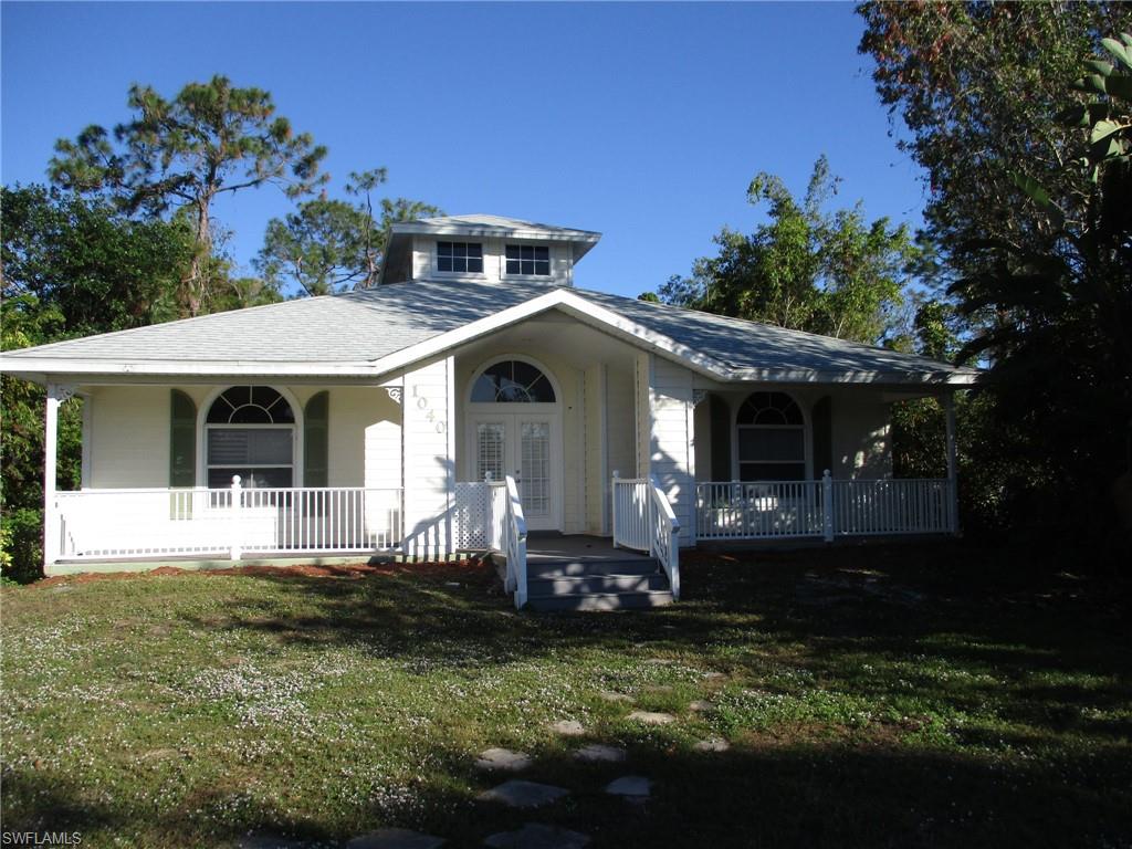 a front view of a house with a garden and porch