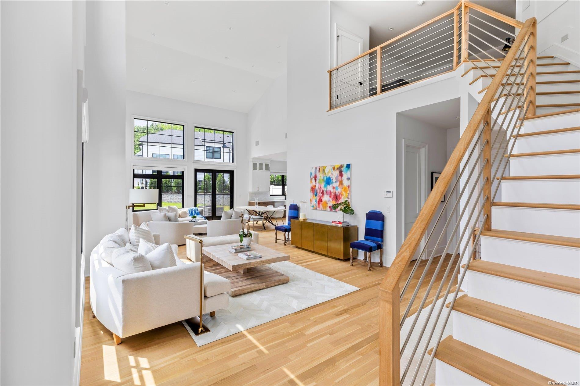 a living room with furniture and a floor to ceiling window