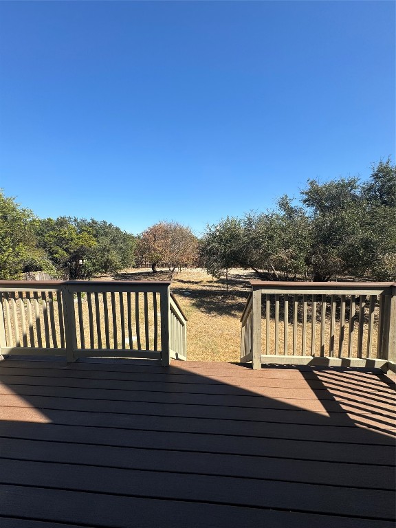 a view of balcony with wooden floor and fence