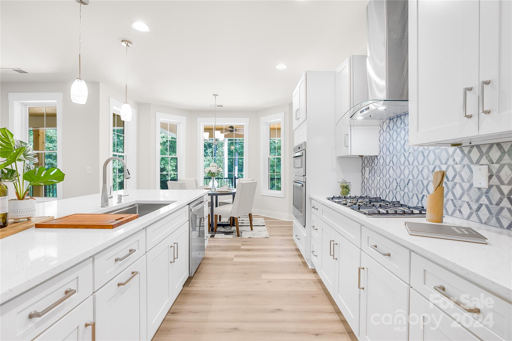 a large kitchen with stainless steel appliances lots of counter space and a sink