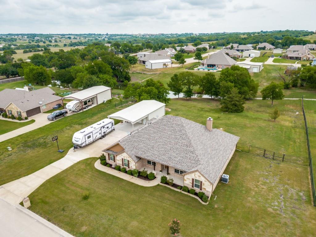 an aerial view of residential houses with outdoor space and river