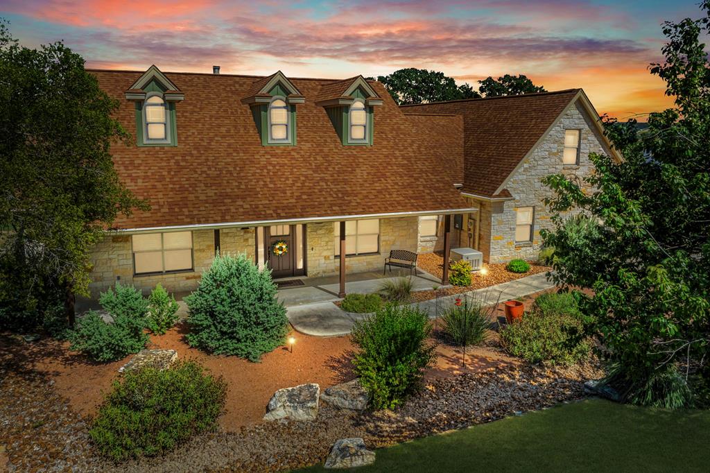 an aerial view of a house with a yard