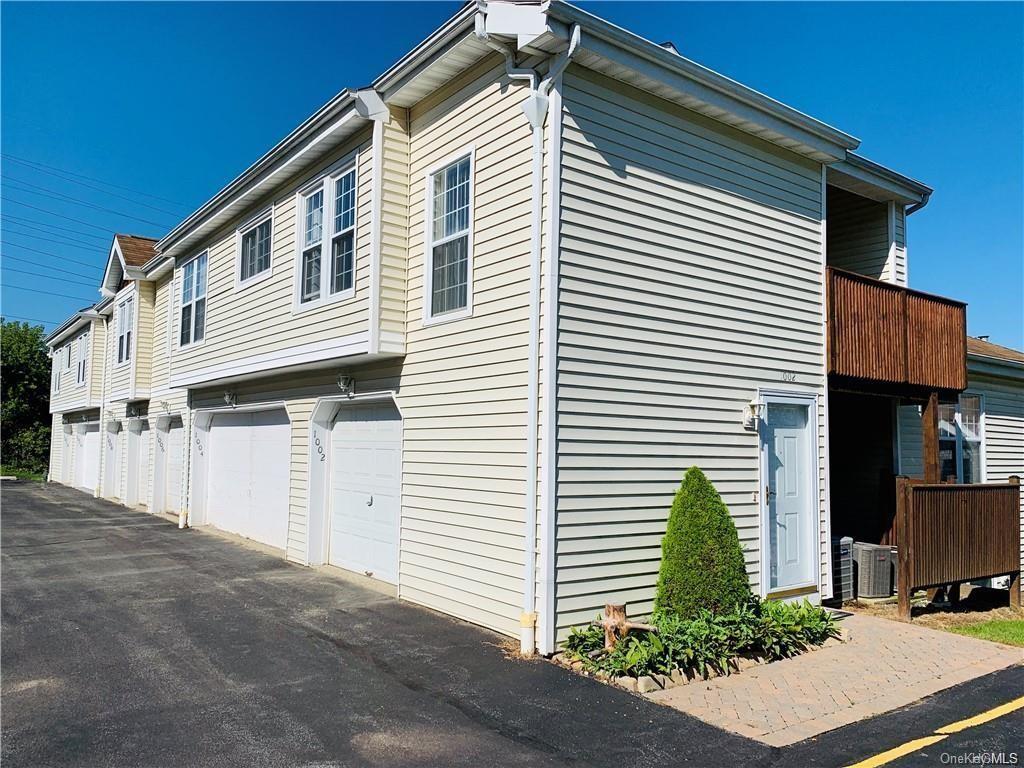 View of side of home featuring central AC unit and a garage