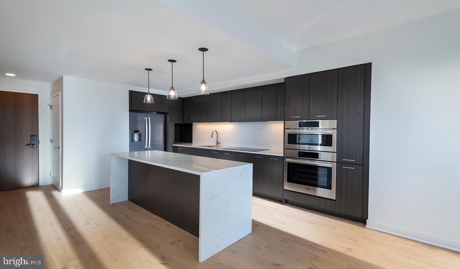 a kitchen with stainless steel appliances granite countertop a stove and a refrigerator