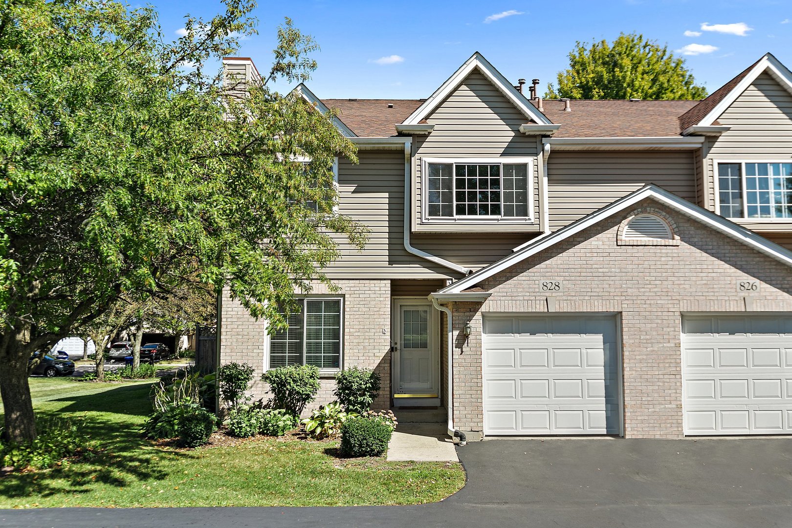 a front view of a house with a yard and garage