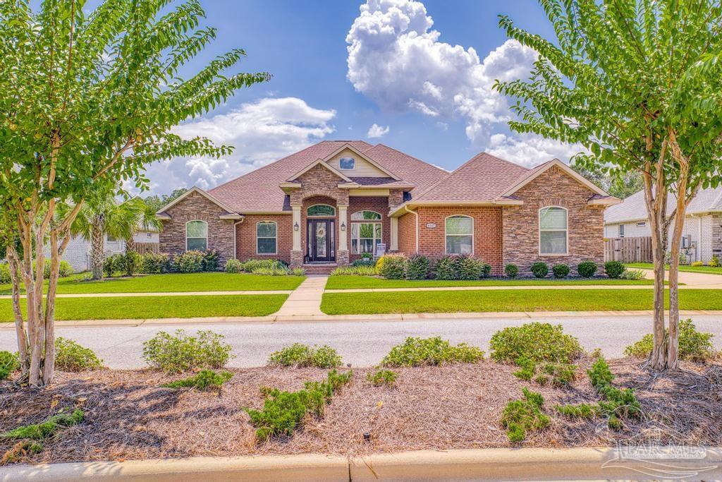 a view of a house with a swimming pool and a yard