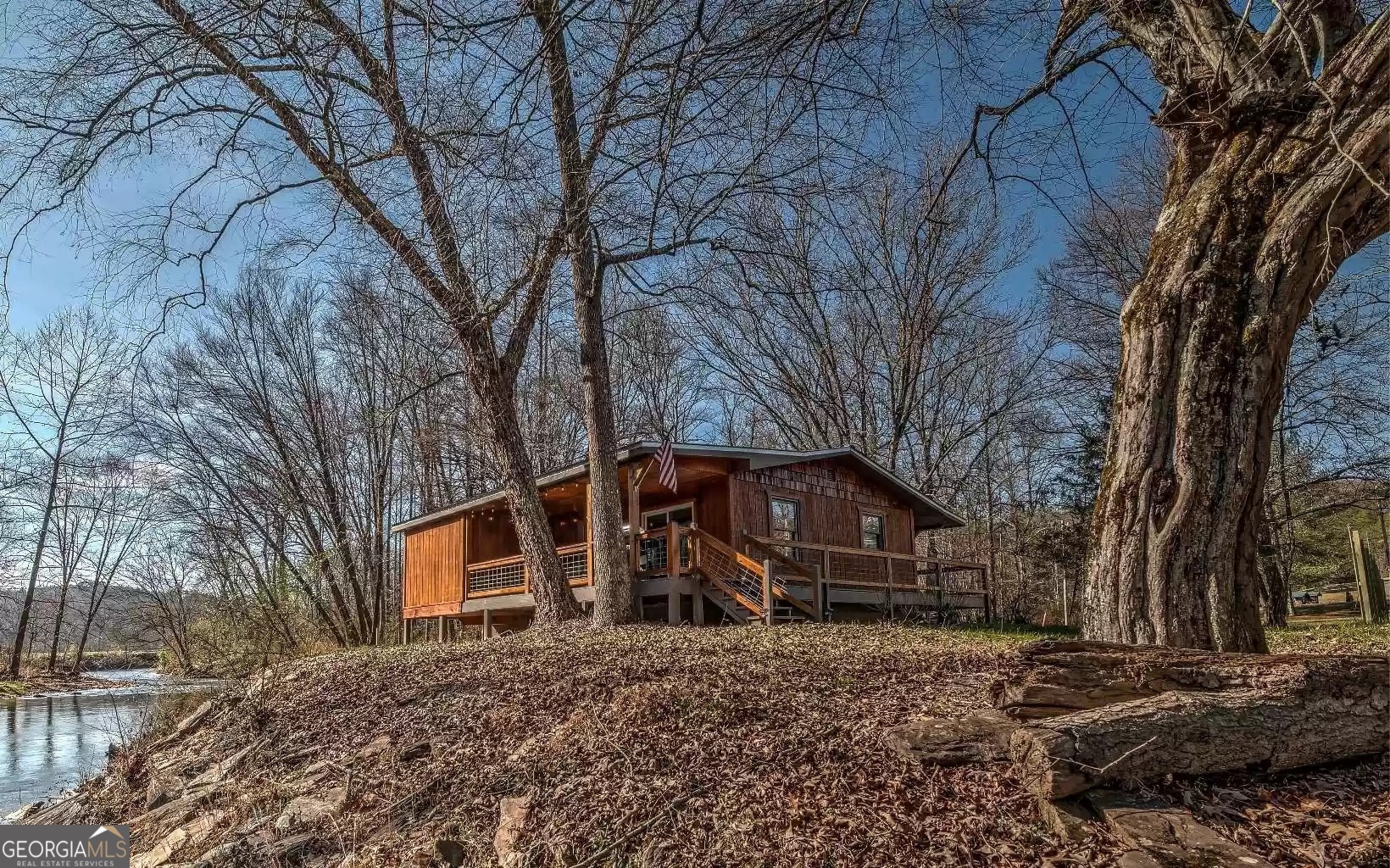 a view of a house with a large tree