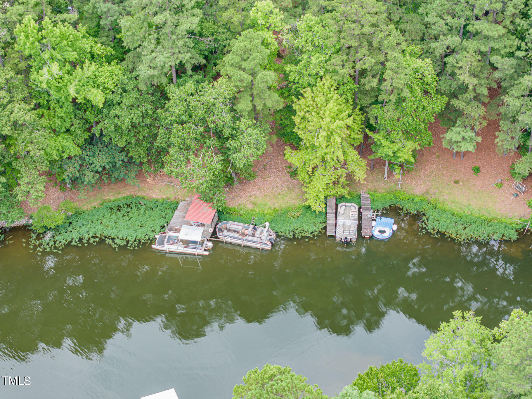 an aerial view of a house with a yard basket ball court and outdoor seating