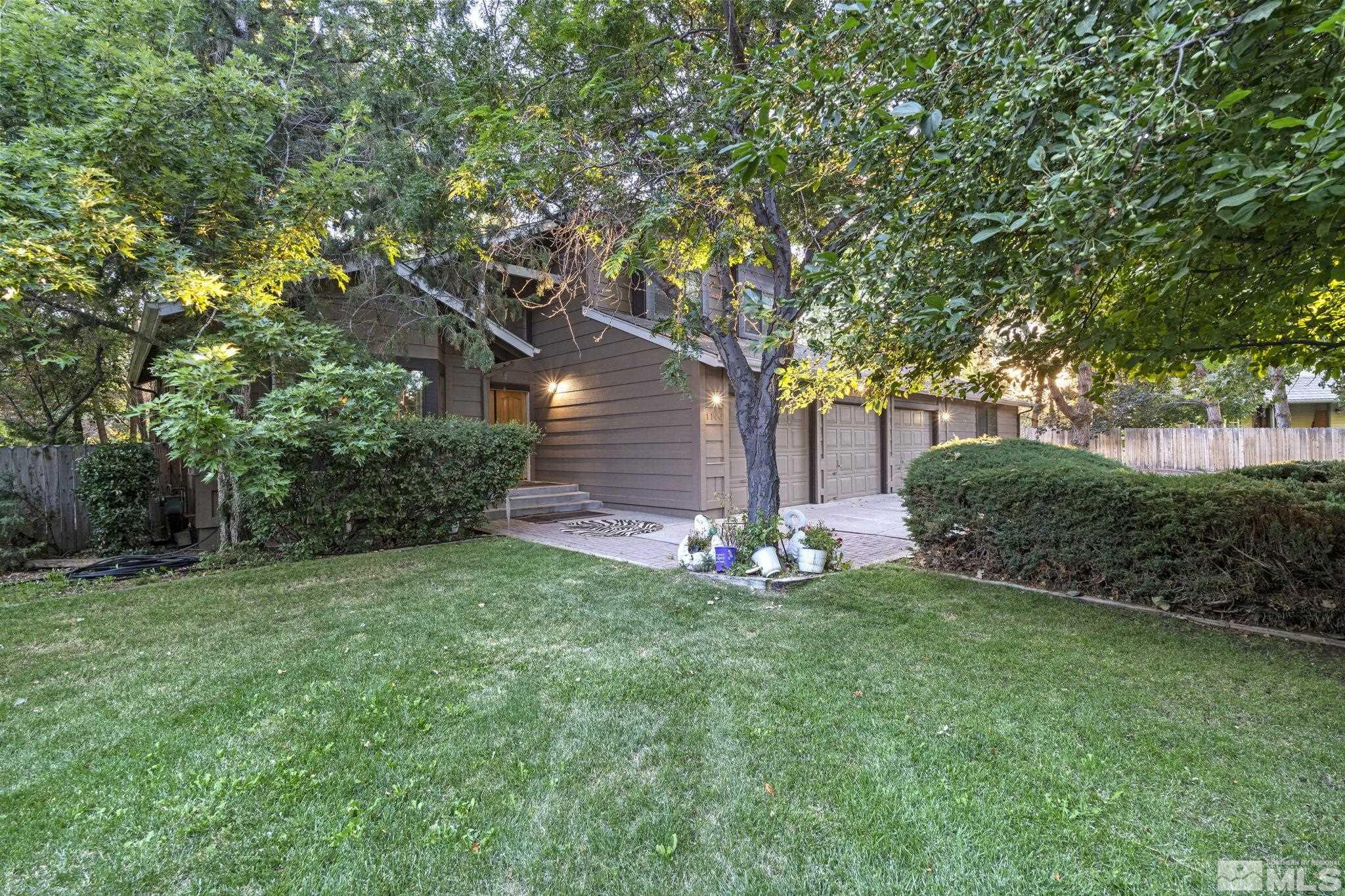 a view of a house with a backyard