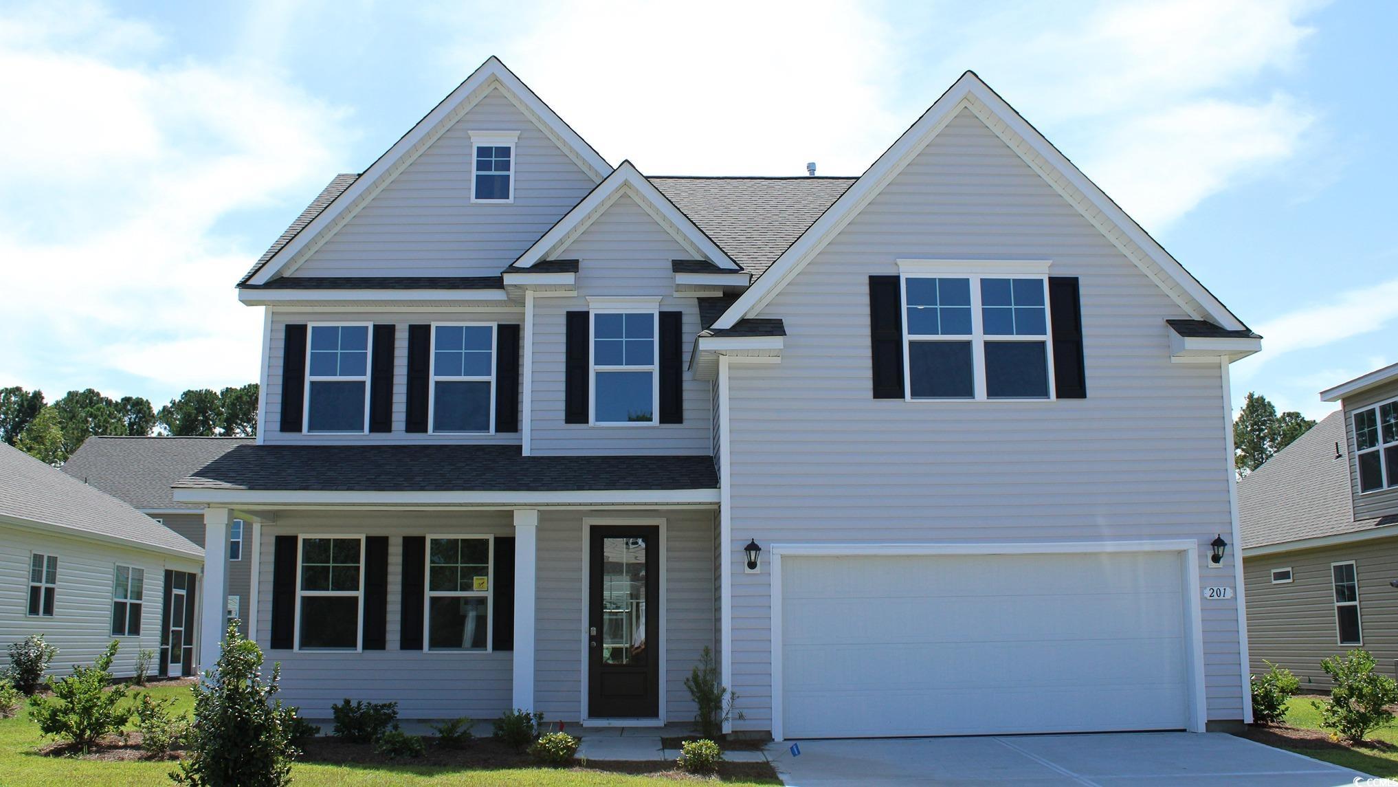 View of front facade featuring a garage