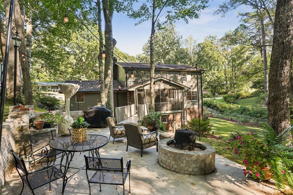 a backyard of a house with table and chairs