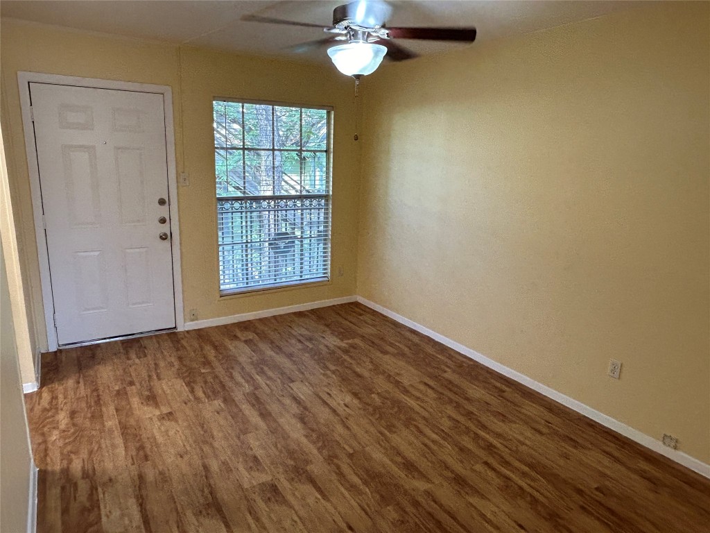 wooden floor in an empty room with a window