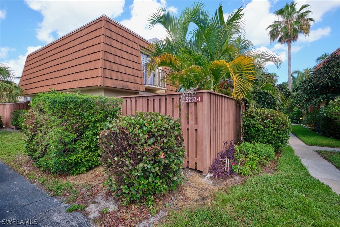 a view of a house with a small yard and plants