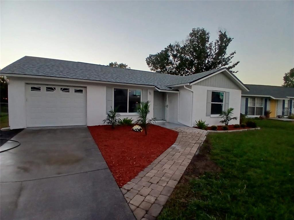 a front view of house with yard and outdoor seating