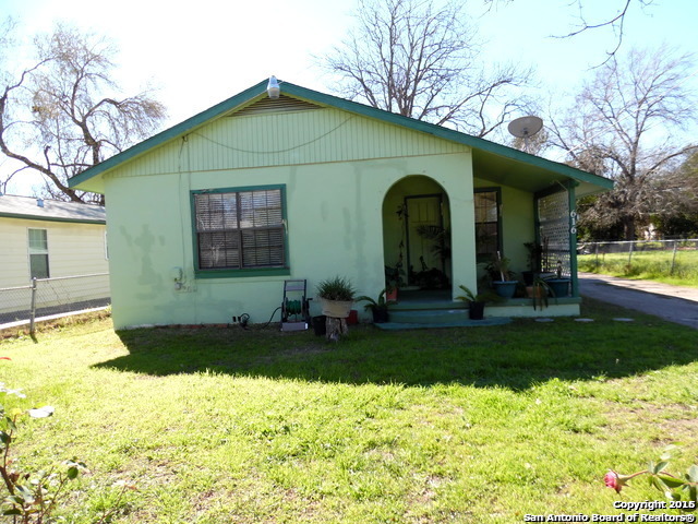 a view of a house with yard and sitting area