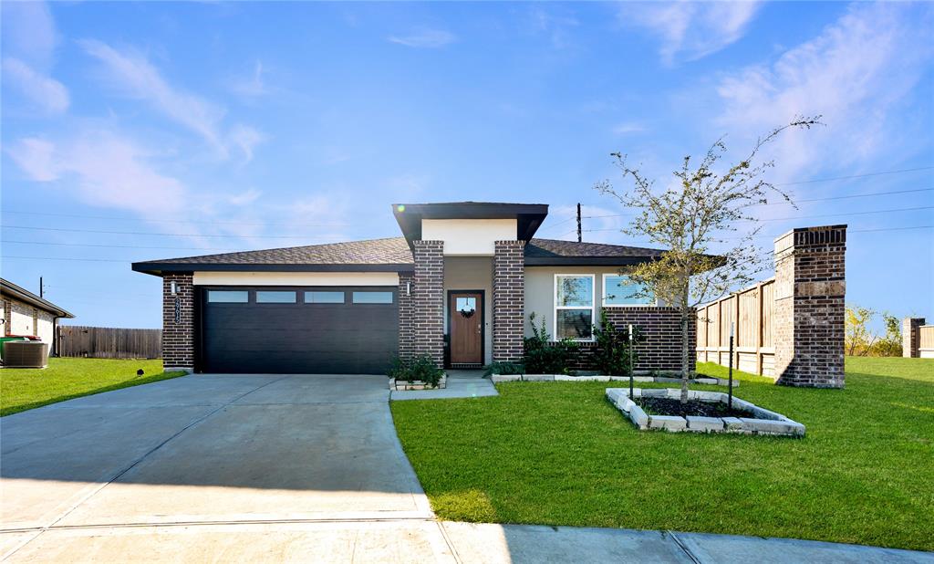 a front view of a house with a yard and garage