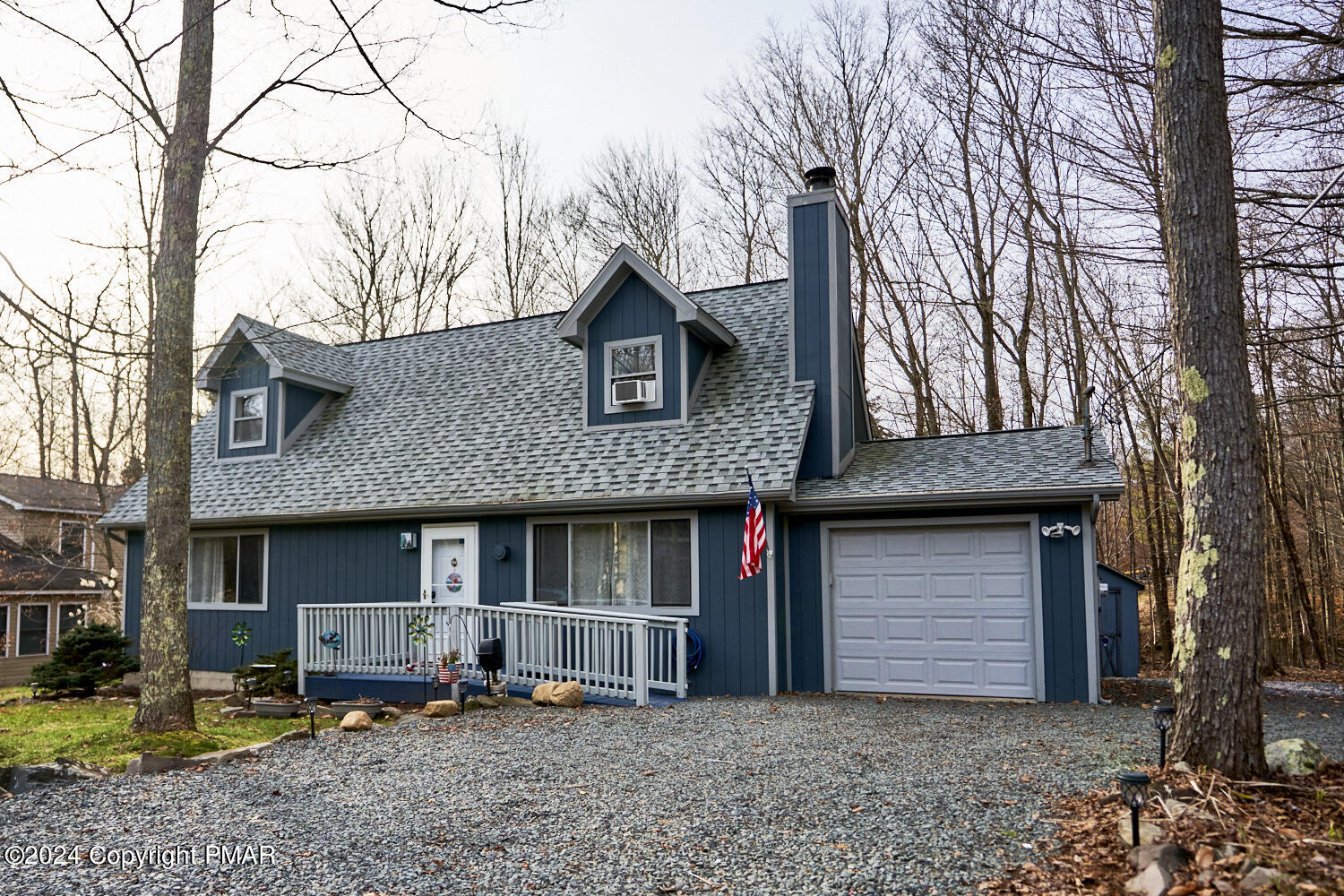 a front view of a house with yard and trees