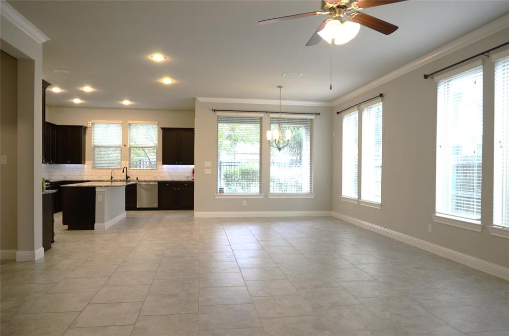 a large kitchen with kitchen island granite countertop a large window