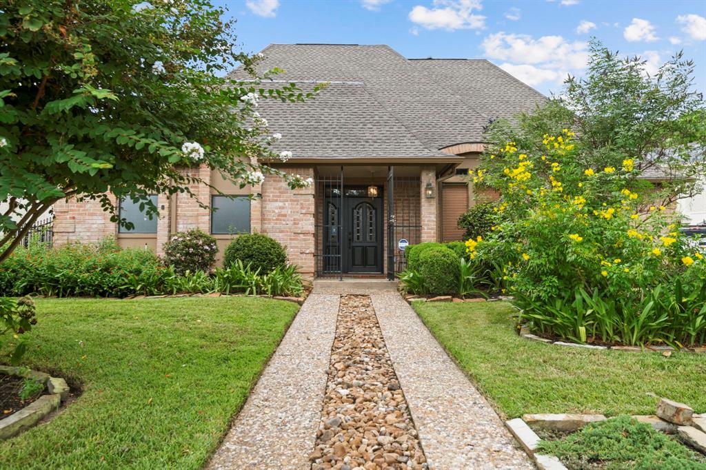 a view of a brick house with a yard