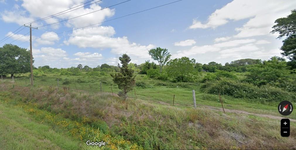 a view of a green field with lots of trees