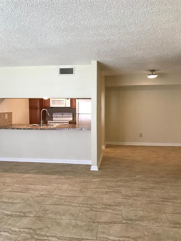 a view of a refrigerator in an empty room