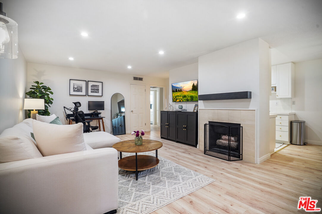 a living room with furniture and a fireplace