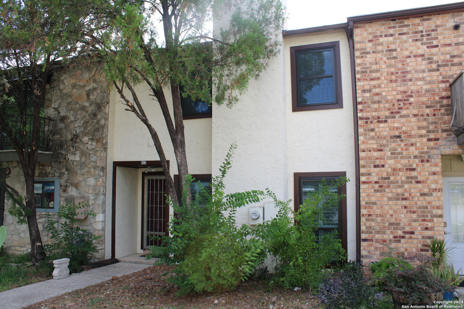 front view of a house with a tree