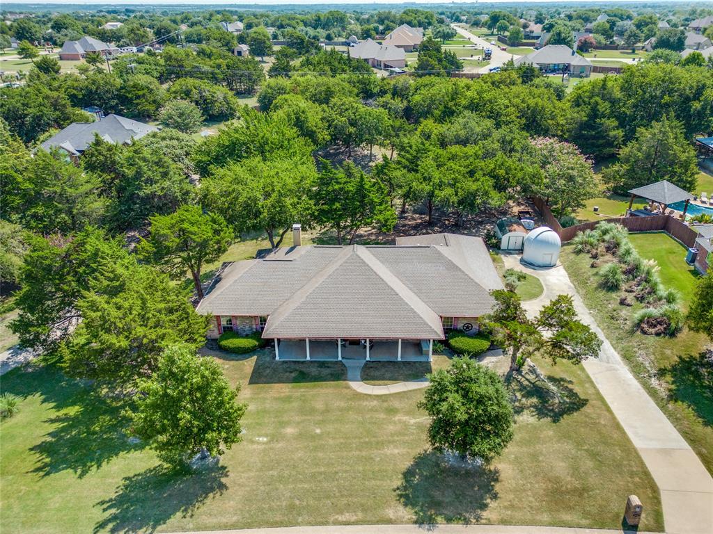 an aerial view of a house with swimming pool and garden