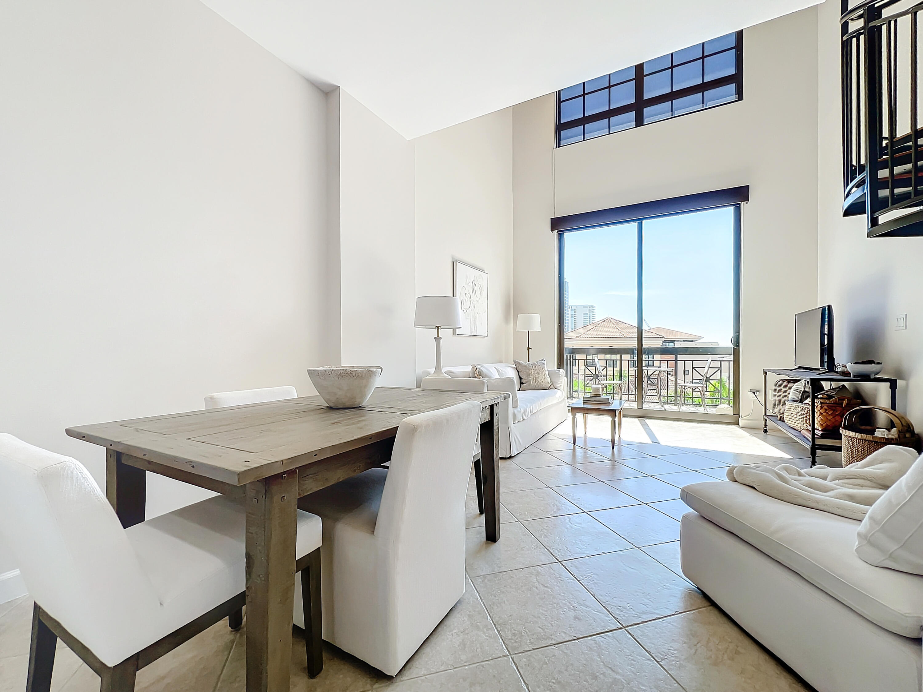 a living room with furniture and a floor to ceiling window