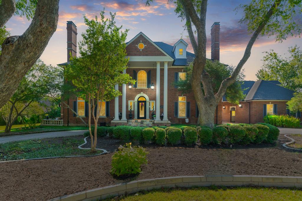 a front view of a house with lots of green space