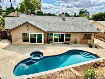 a view of house with swimming pool outdoor seating