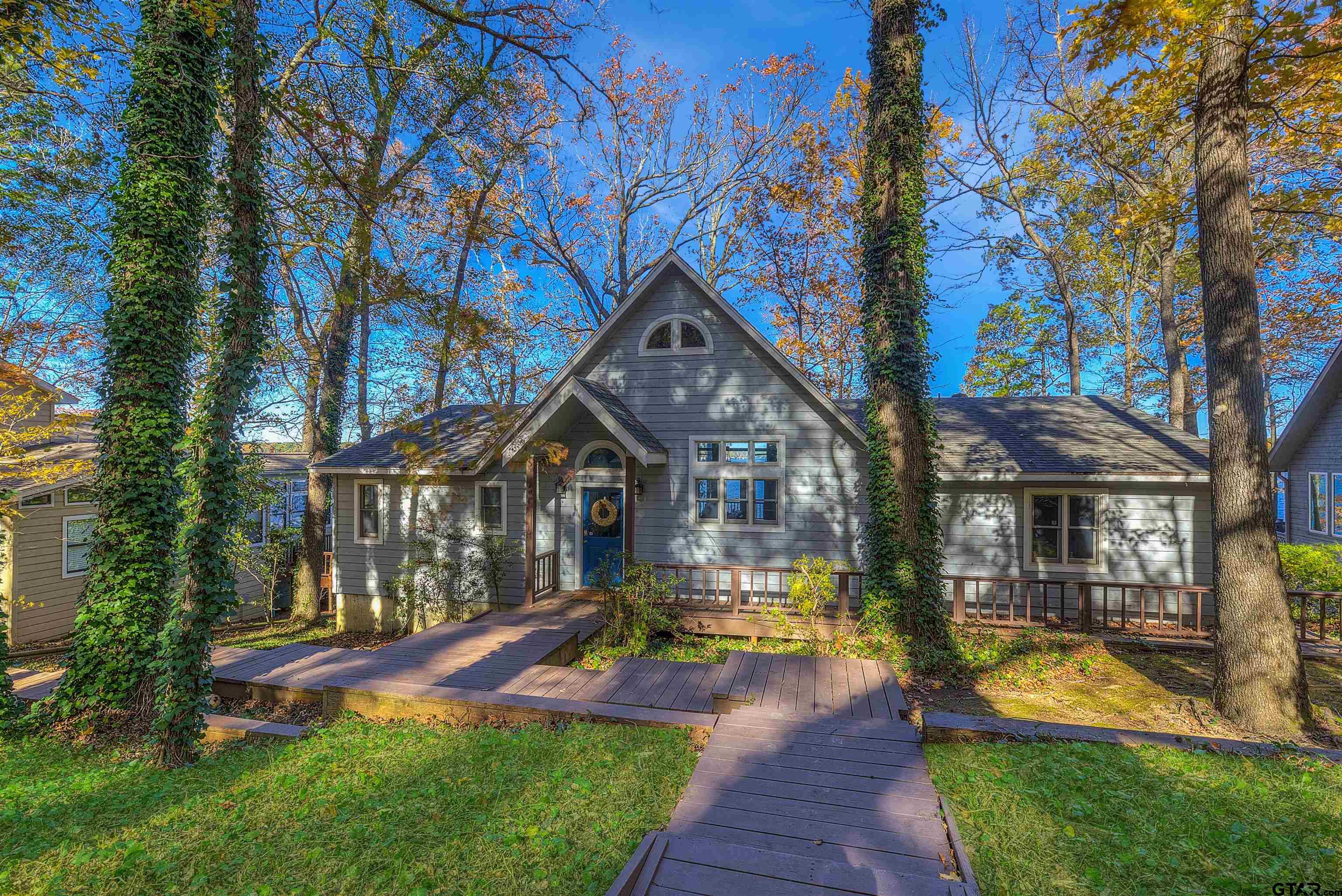 a front view of a house with swimming pool and porch