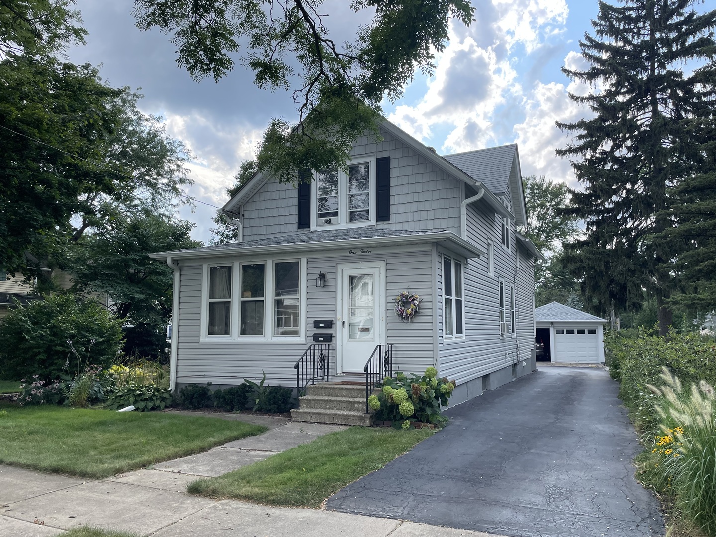 a front view of a house with garden