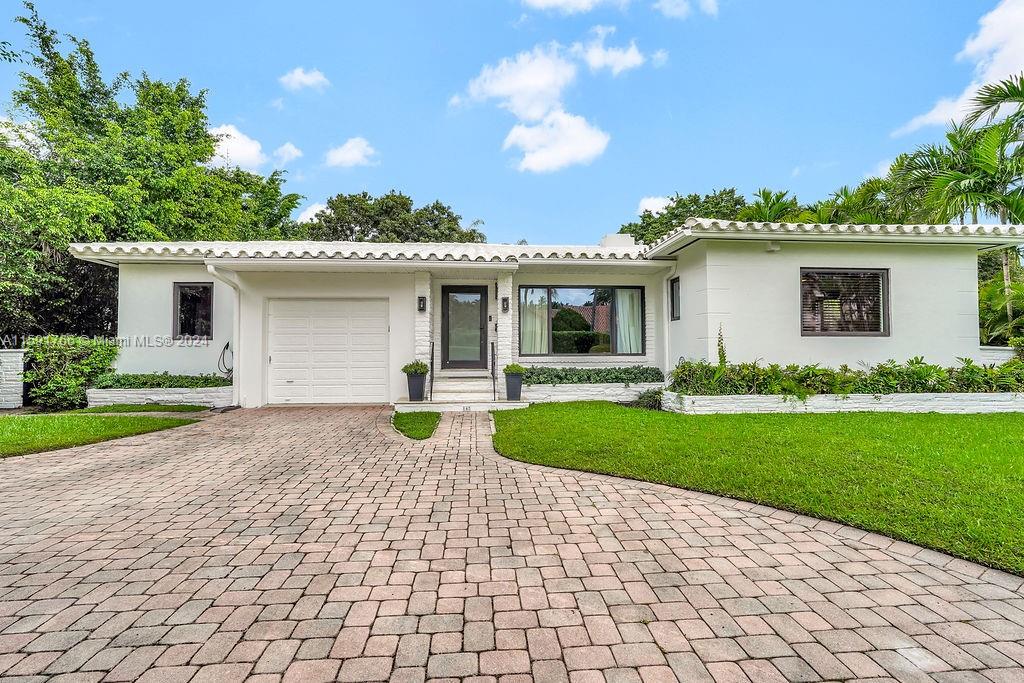 a front view of a house with garden