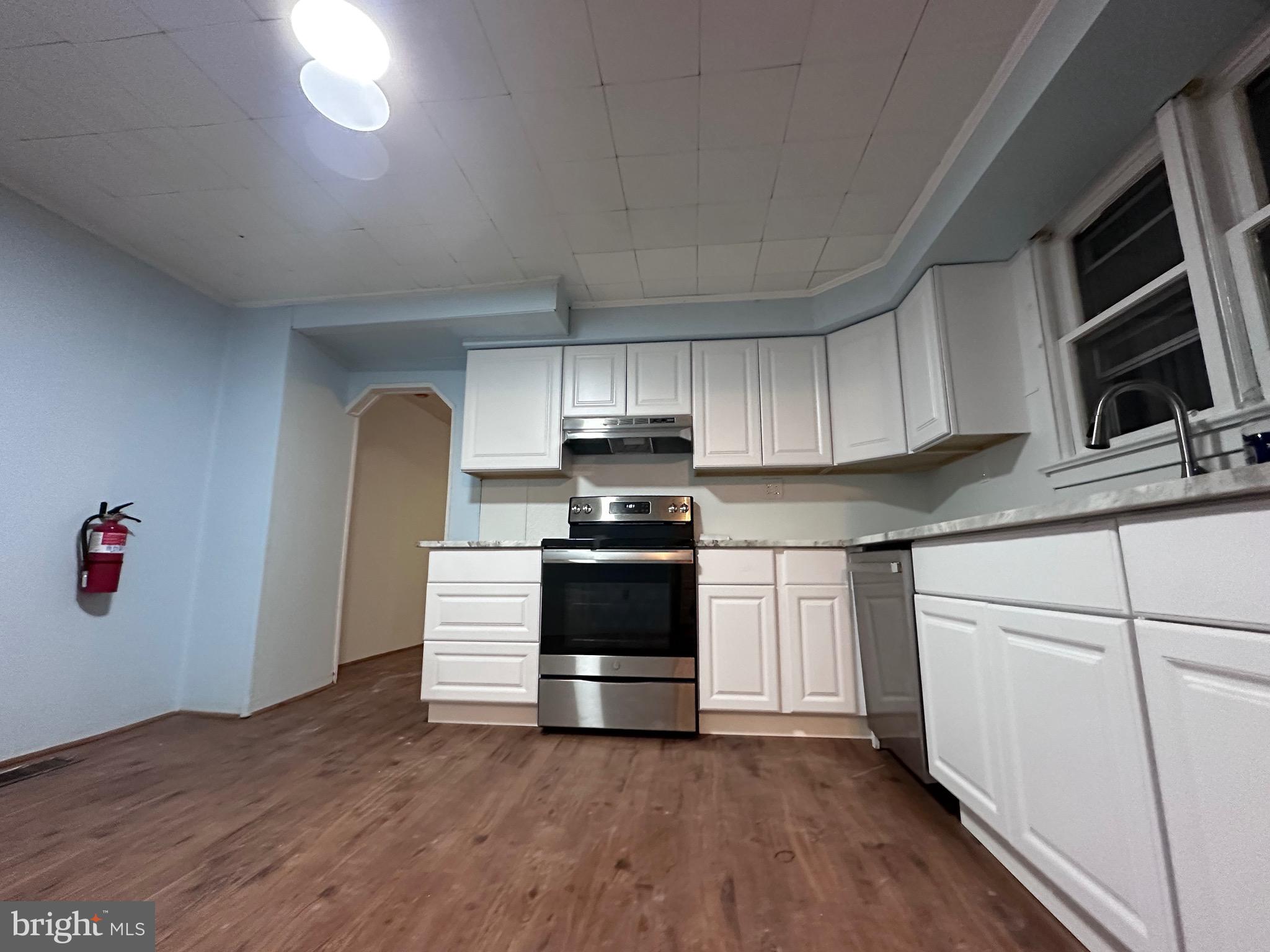 a kitchen with a stove and a refrigerator