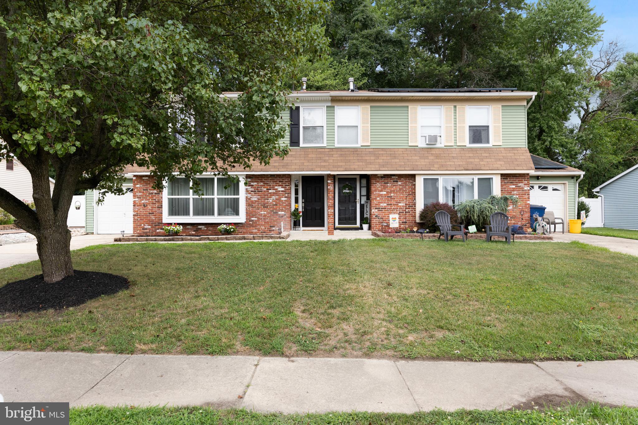 a front view of a house with a garden