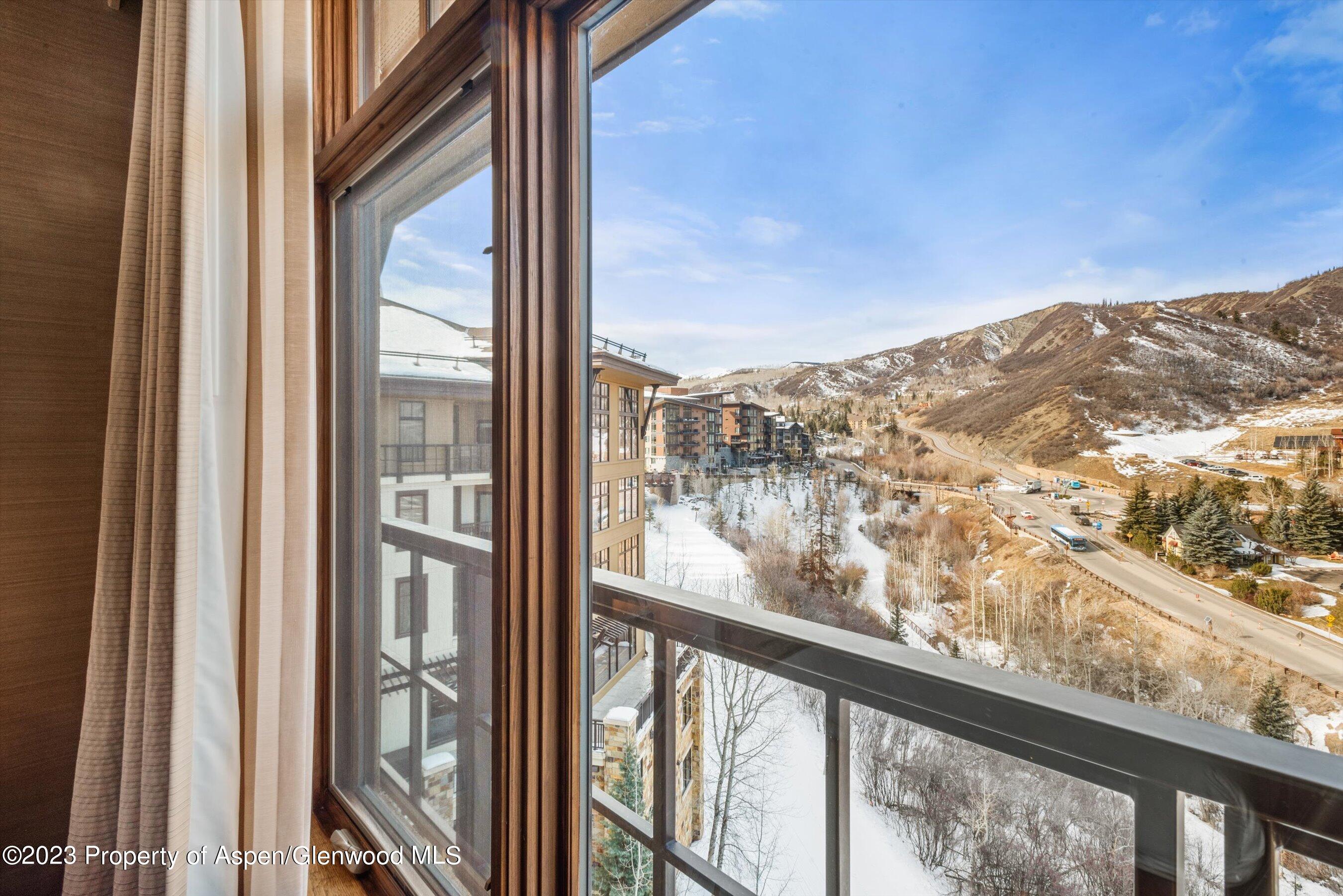 a view of a glass door with a view of mountain