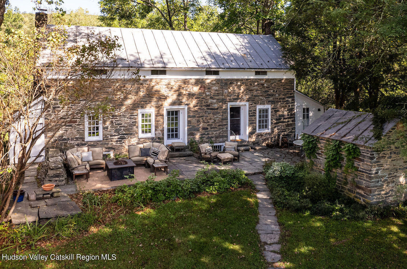 a view of a house with backyard sitting area and garden