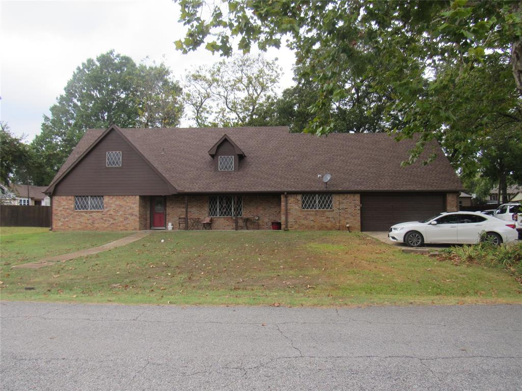 a house that has a tree in front of it