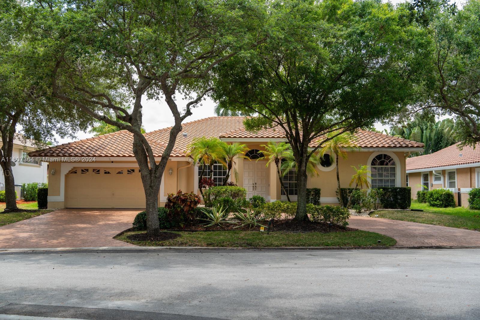 a front view of house with yard and green space