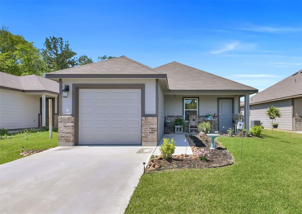 a front view of a house with a yard and porch