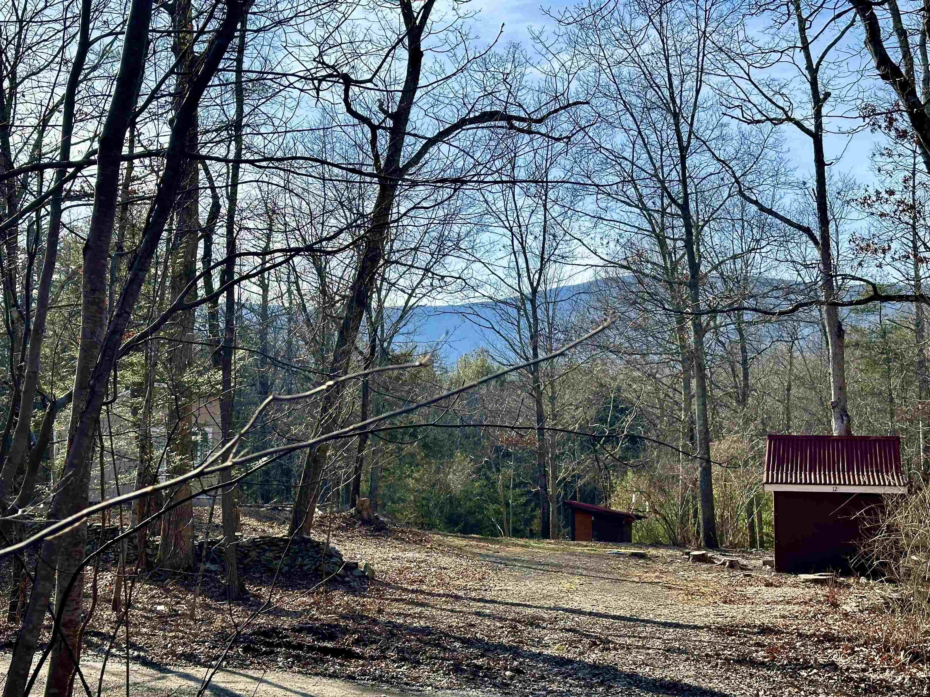 a view of a wooden house with a yard