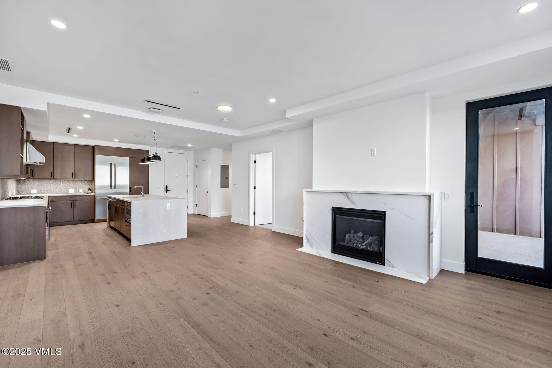 a view of kitchen with furniture and a fireplace