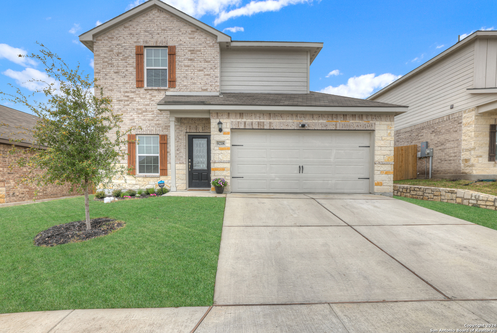 a front view of a house with a yard and garage