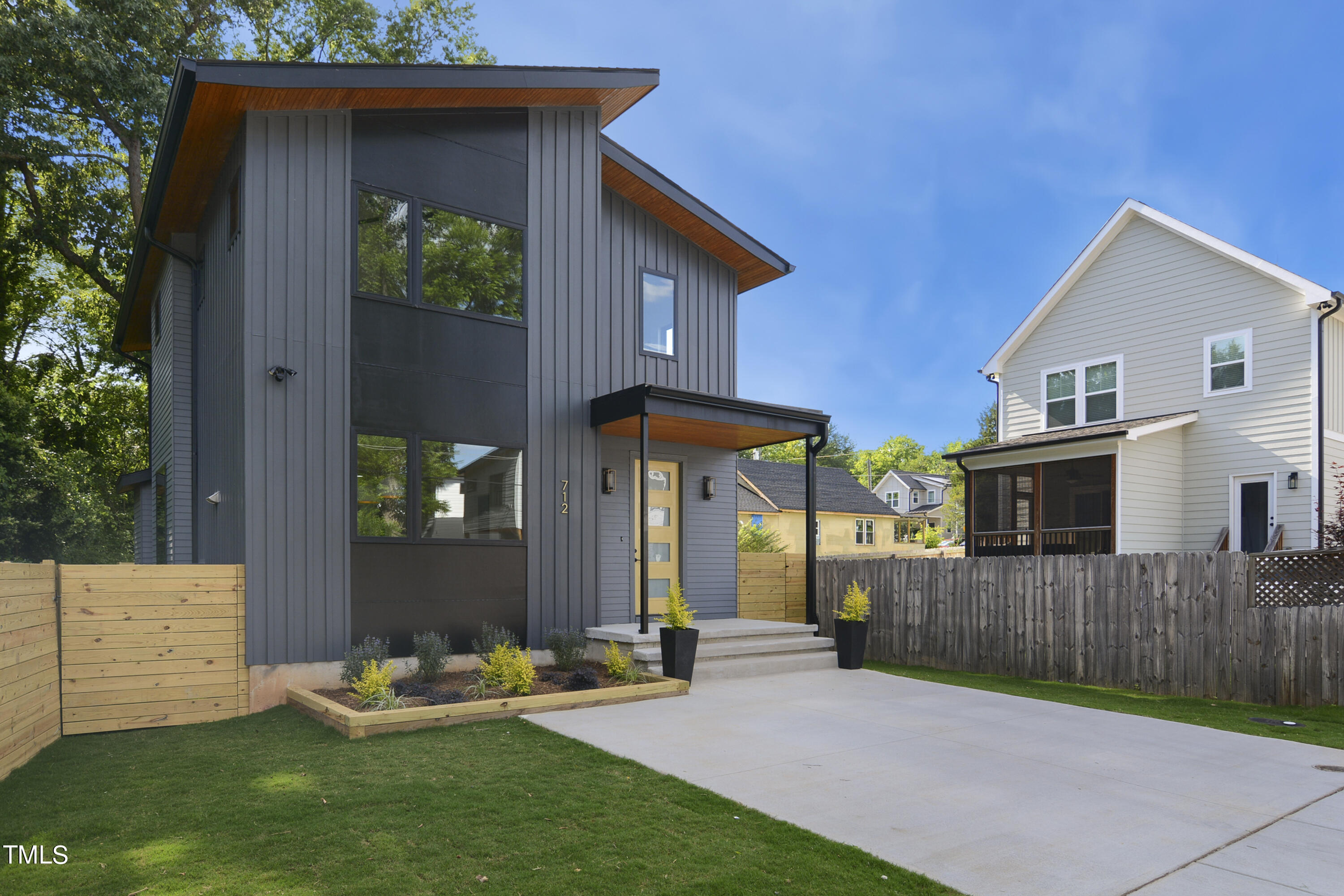 a backyard of a house with table and chairs