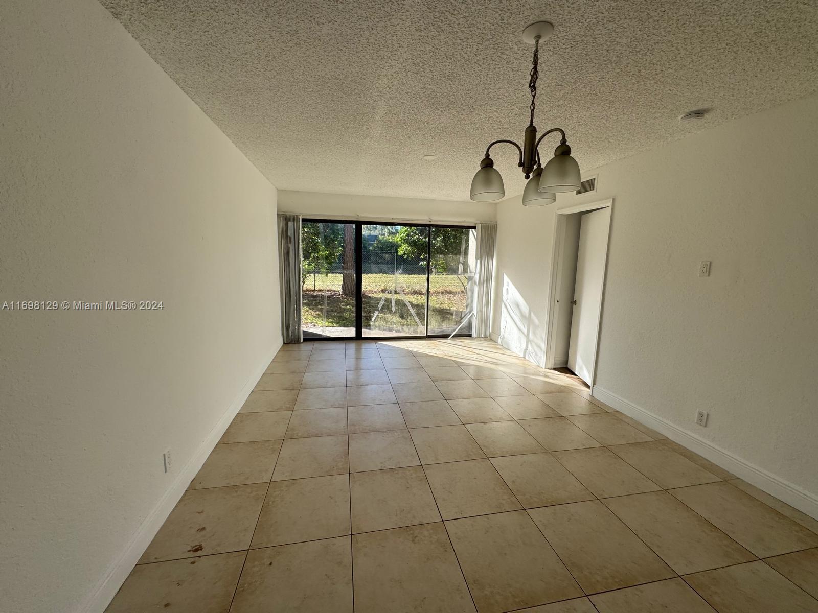 a view of a livingroom with wooden floor and a window